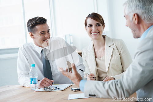 Image of Laughing,, smile or business people in meeting for teamwork or planning growth strategy ideas. Happy, humor and CEO speaking of funny joke with group of employees, colleagues or workers in boardroom