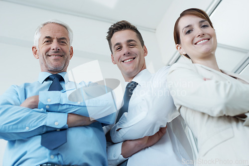 Image of Pride, crossed arms and portrait of business people in office with positive, good and confident attitude. Happy, smile and team of lawyers in meeting for collaboration in workplace from below.