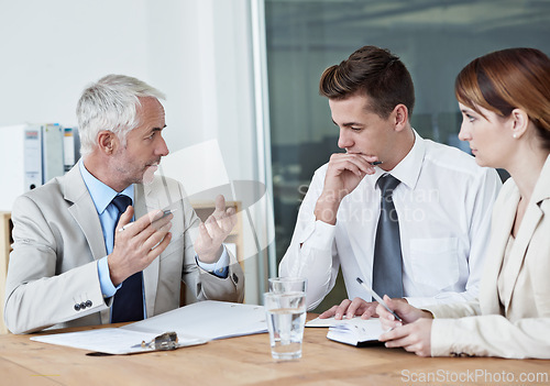 Image of Business people, leader or planning on paperwork for collaboration, strategy or notes at office. Senior CEO, teamwork or employees with documents or report in meeting for brainstorming at workplace