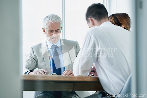 Image of Business people, writing and contract paperwork for collaboration, strategy or notes at office. Group, teamwork or employees with documents or negotiation in meeting for brainstorming at workplace
