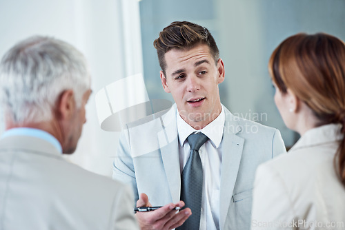 Image of Discussion, interview and hr with candidate in office for business meeting, onboarding or recruitment. Conversation, hiring and man talking to human resources managers in workplace boardroom.