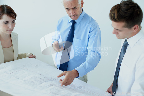 Image of Blueprint, people or civil engineering team in office planning project, maintenance or renovation in meeting. Architecture, building or designers with floor plan for property development ideas
