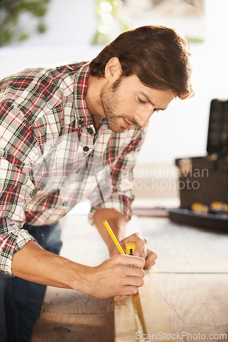 Image of Man, carpenter and desk with wood, thinking and building for renovation, repair and maintenance. Craftsman, handyman and contractor with diy, craft and artisan for woodwork, home improvement or work