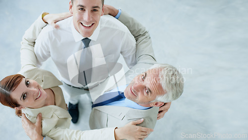 Image of Business people, portrait and huddle for solidarity or support in workplace, teamwork and together. Coworkers, top view and united in embrace or coworkers in office, collaboration and hug in meeting