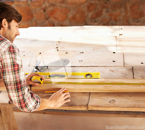 Image of Handyman, marking and measuring tape on wood in workshop, home repairs and professional with plan. Person, working and handcraft with maintenance, job and career in industry, skill and technique