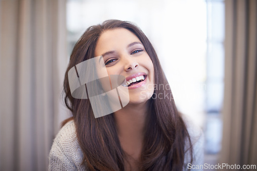 Image of Woman, laugh and relax in home portrait with happiness on holiday or vacation with comfort in hotel. Travel, accommodation and girl with a smile in lounge at lodge with joke, humor or funny memory