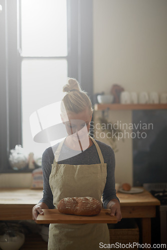 Image of Bakery, kitchen and woman with bread on tray for cooking with healthy gluten free food for breakfast. Fresh, loaf and chef in restaurant with rye or sourdough for brunch, meal or lunch with nutrition