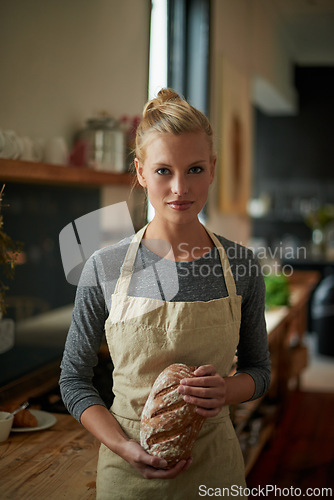 Image of Bakery, kitchen and portrait of woman with bread, cooking gluten free food and healthy breakfast. Fresh, loaf and chef in restaurant with rye or sourdough after preparation process of brunch or lunch