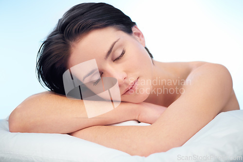 Image of Skincare, sleeping or face of woman in studio isolated on blue background for wellness in spa or salon. Facial, relax or natural results of model, lady or confident person with shine, beauty or glow