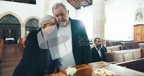 Image of Funeral, coffin and senior couple hug in church for goodbye, mourning and grief in memorial service. Depression, sad family and man embrace woman by casket for greeting, loss and burial for death