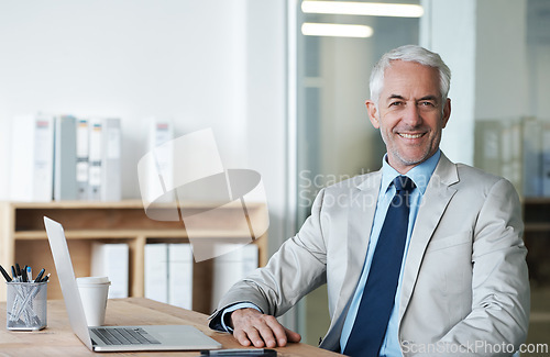 Image of CEO, businessman and laptop at desk, portrait and work for lawyer firm. Senior executive, office and smile at company, suit and success in corporate workspace for attorney and insurance lawyers