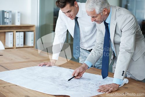 Image of CEO, architect and boss with blue print, plan and work for expanding in office and building. Manager, employer and designer at table, company and meeting for remodeling of business and renovation