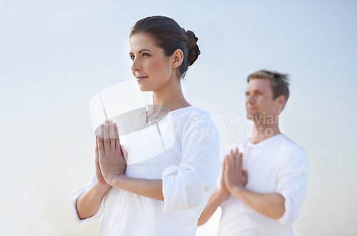 Image of Couple outdoor, meditation and prayer for zen with blue sky, mindfulness for holistic healing and wellness. Spiritual, aura and chakra balance together for bonding, stress relief and peace in nature