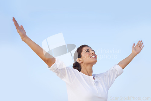 Image of Woman, freedom and happy outdoor with blue sky, arms out for worship or gratitude in nature. Praying, mindfulness and smile with wellness, healing and care free, faith or spiritual for peace of mind