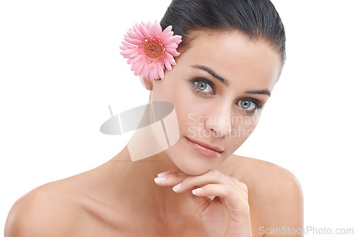 Image of Woman, portrait and flower for skincare in studio with beauty, floral cosmetics or dermatology. Face of a young model or person with pink daisy for makeup with creative or scent on a white background