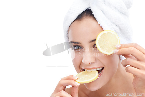 Image of Woman, skincare and lemon in studio portrait for beauty, cosmetics and natural health or vitamin c benefits. Face of a young model eating fruits with eye dermatology or detox on a white background