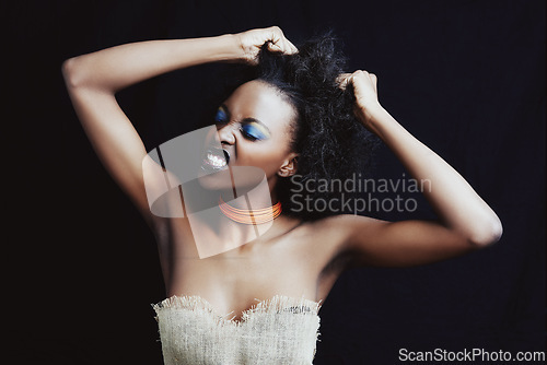 Image of Beauty, hair care and frustrated black woman on dark background for hairstyle, texture and natural afro. Stress, salon crisis and angry African person with cosmetics, accessories and makeup in studio