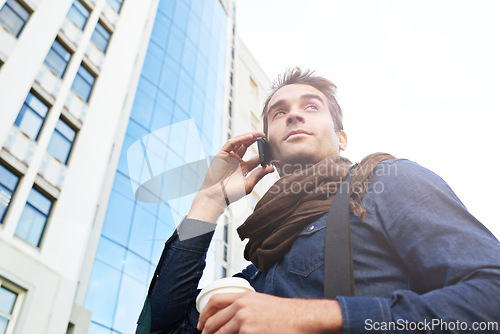 Image of Man, smartphone and smile in city for phone call, conversation or networking in Los Angeles. Male person, technology and confidence with communication, contact and happy in morning from low angle