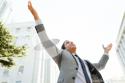 Image of Business man, city and celebration for promotion, bonus and salary increase or achievement. Male person, low angle and professional in outdoors for corporate success, proud and happy for information