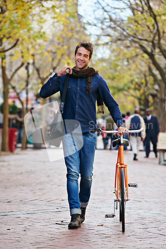 Image of Happy man, portrait and push bicycle in city to travel on eco friendly transport outdoor, commute and trip. Cycling, person and bike in urban town, street and road for journey at sidewalk of park