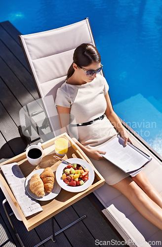 Image of Breakfast, documents and business woman poolside, reading information on work trip from above. Food, paper and woman employee sitting outdoor at hotel swimming pool for contract review or hospitality