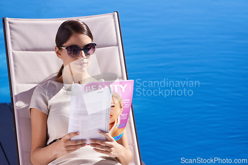 Image of Woman, reading and magazine on sunbed by pool with sunglasses for relax, article and lifestyle news. Person, publication and paper outdoor on holiday, vacation and summer trip at hotel or resort