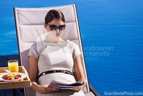 Image of Woman, reading and magazine on sunbed outdoor with sunglasses for relax, snacks and lifestyle news. Person, publication and paper by pool on holiday, vacation and summer trip at hotel or mockup space