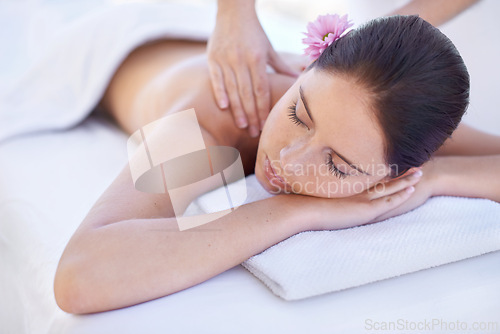 Image of Relax, massage and woman at spa with flower for health, wellness and luxury holistic treatment. Self care, peace and girl on table with masseuse for body therapy, sleep and rest with hotel service