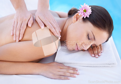 Image of Relax, massage and woman at spa pool with flower for health, wellness and luxury holistic treatment. Self care, peace and girl on table with masseuse for body therapy, sleep and calm hotel service