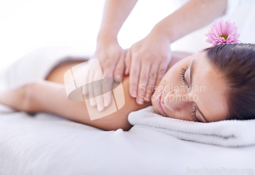 Image of Relax, massage and woman at hotel spa with flower for health, wellness and luxury holistic treatment. Self care, peace and girl on table with masseuse for body therapy, sleep and calm service.