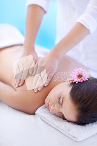 Image of Relax, massage and woman at hotel pool with flower for health, wellness and luxury holistic treatment. Self care, peace and girl on table with masseuse for body therapy, sleep and calm spa service