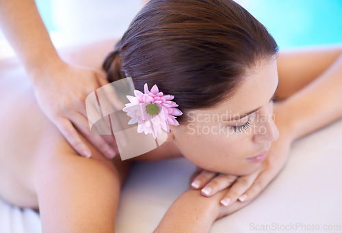 Image of Rest, massage and woman at spa with flower for health, wellness balance and luxury holistic treatment. Self care, peace and girl on table with masseuse for body therapy, relax and calm hotel service