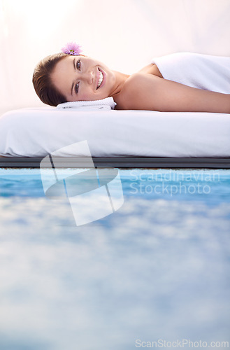 Image of Massage, portrait and woman at spa poolside for health, wellness and luxury holistic treatment. Self care, peace and face of girl on pool bed for body therapy, comfort and calm hotel service to relax