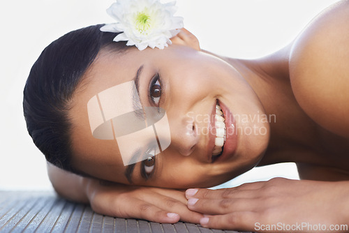 Image of Flower, relax or portrait of happy woman in resort for wellness, cosmetics or hospitality in hotel. Calm peace, smile or person in spa on break or holiday vacation for beauty, skincare or health