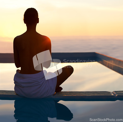 Image of Rear view, yoga and meditation of woman at sunset by swimming pool for healthy body, wellness and zen outdoor on mockup space. Back, mindfulness or person by water at twilight to relax, peace or calm