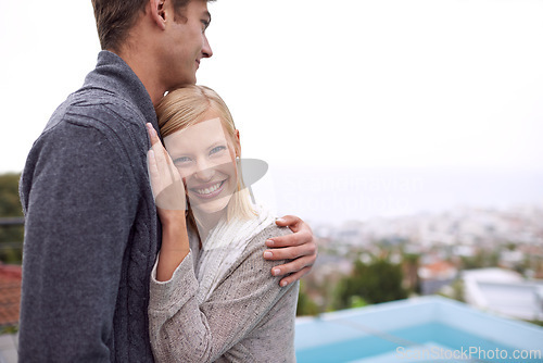 Image of Couple, portrait and happy with hug outdoor in city for holiday, vacation or anniversary getaway on balcony. Love, man and woman with face, smile and embrace in nature for relationship, care or relax