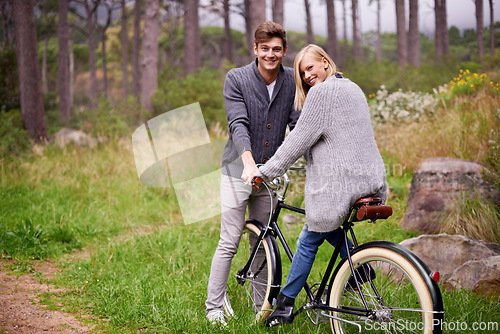 Image of Couple, portrait and forest with retro bicycle on holiday, adventure and date with sustainable transport. Man, woman and vintage bike with smile for holiday with journey in woods, path or environment