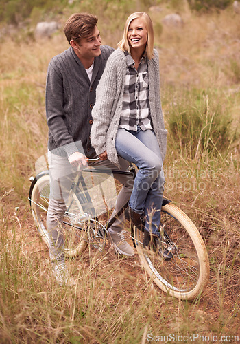 Image of Couple, happy and field with retro bicycle on holiday, adventure or date with sustainable transport. Man, woman and vintage bike with smile for vacation with journey in nature, path or environment