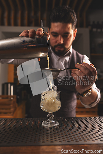 Image of Expert bartender crafting a cocktail