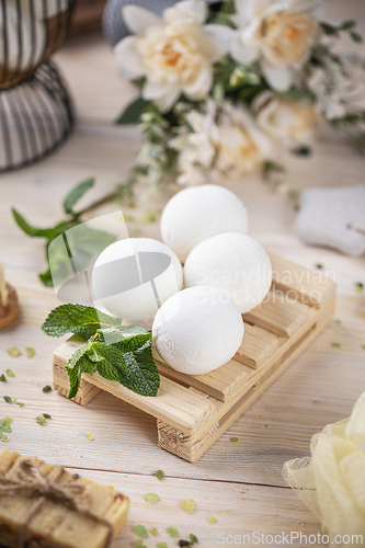 Image of Elegant bath bombs arranged on a wooden tray