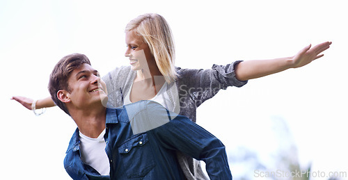 Image of Couple, piggy back and plane with arms, smile or game by trees with care for connection with bonding outdoor. Man, woman and playful with airplane, wings or flight for freedom on journey for vacation