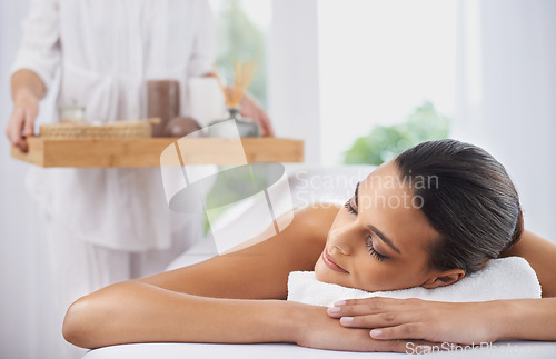 Image of Peace, massage and woman at spa to relax, beauty and pamper for wellness at luxury salon. Therapist, calm and person in treatment for skincare, wellbeing and resting for healthy body with masseuse