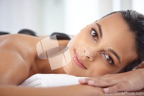 Image of Portrait, hot stone and woman with massage for relaxing at spa for wellness, health and back treatment. Self care, cosmetic and female person with warm stone back therapy at natural beauty salon.