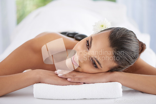 Image of Woman, hot stone massage and treatment for relaxing, wellness and muscle therapy for body care. Female person, skin detox and satisfaction at resort, beauty and resting for skincare and peace or zen