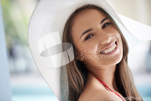 Image of Relax, portrait and happy woman at pool with hat, sunshine and travel for summer holiday at hotel. Smile, water and face of girl on luxury vacation with adventure, weekend and swimming in sun in USA.