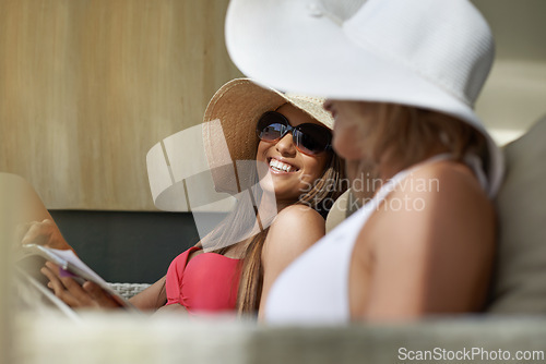 Image of Friends, women and bonding or relaxing at hotel, getaway and resting on tropical vacation. Happy people, reading news and magazine for gossip on summer holiday, weekend trip and travel to resort