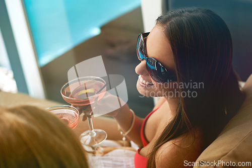 Image of Women, friends and cocktail at swimming pool for summer party with alcohol for relax, sunshine or vacation. Female people, drinks and cheers on patio in Miami for bikini holiday, bonding or weekend