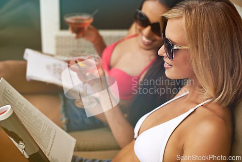 Image of Friends, women and bonding with alcohol at hotel, getaway and drinking wine on tropical vacation. People, reading news and magazine for gossip on summer holiday, weekend trip and travel to resort