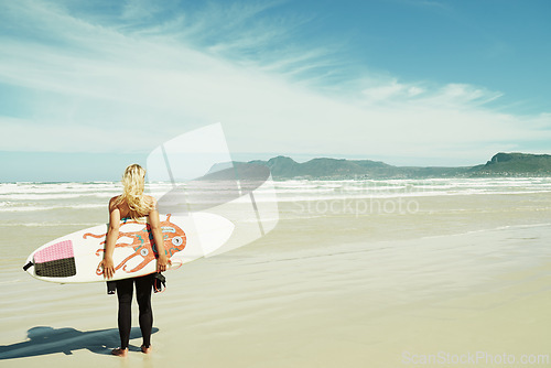 Image of Beach, summer and woman with surfboard on space for travel, vacation or holiday on tropical coast. Fitness, sky and sand with surfer person outdoor in nature for exercise or training from back