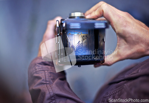 Image of Vintage, camera and photography on screen in hands of person with photoshoot in city to film street. Travel, photographer and creative cameraman closeup with retro lens to capture urban media outdoor